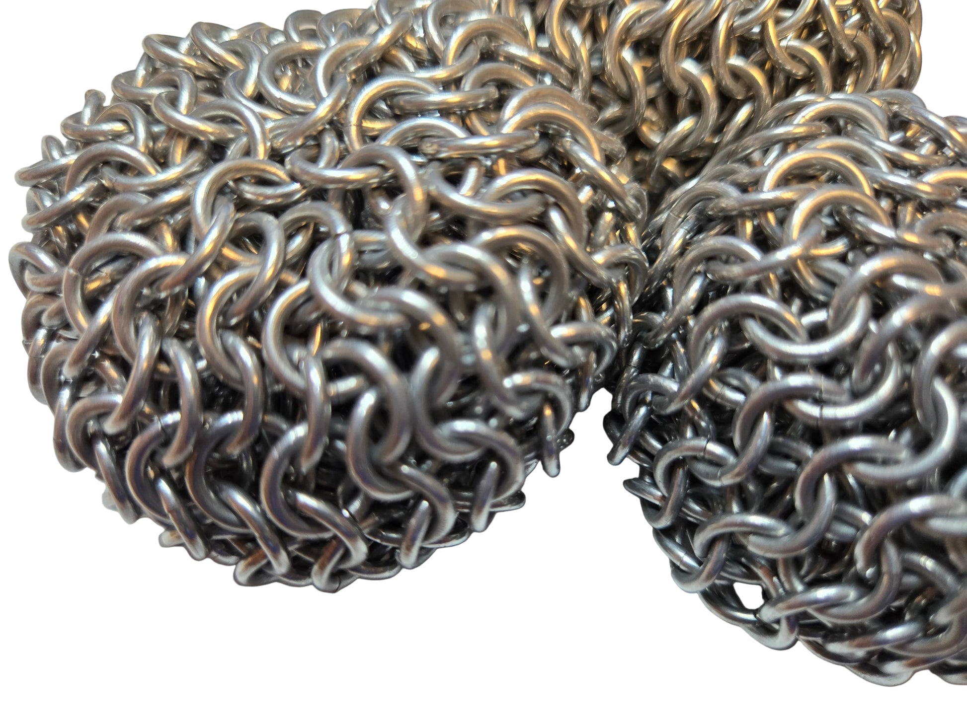 Close-up of a metal chainmail ball on a white background