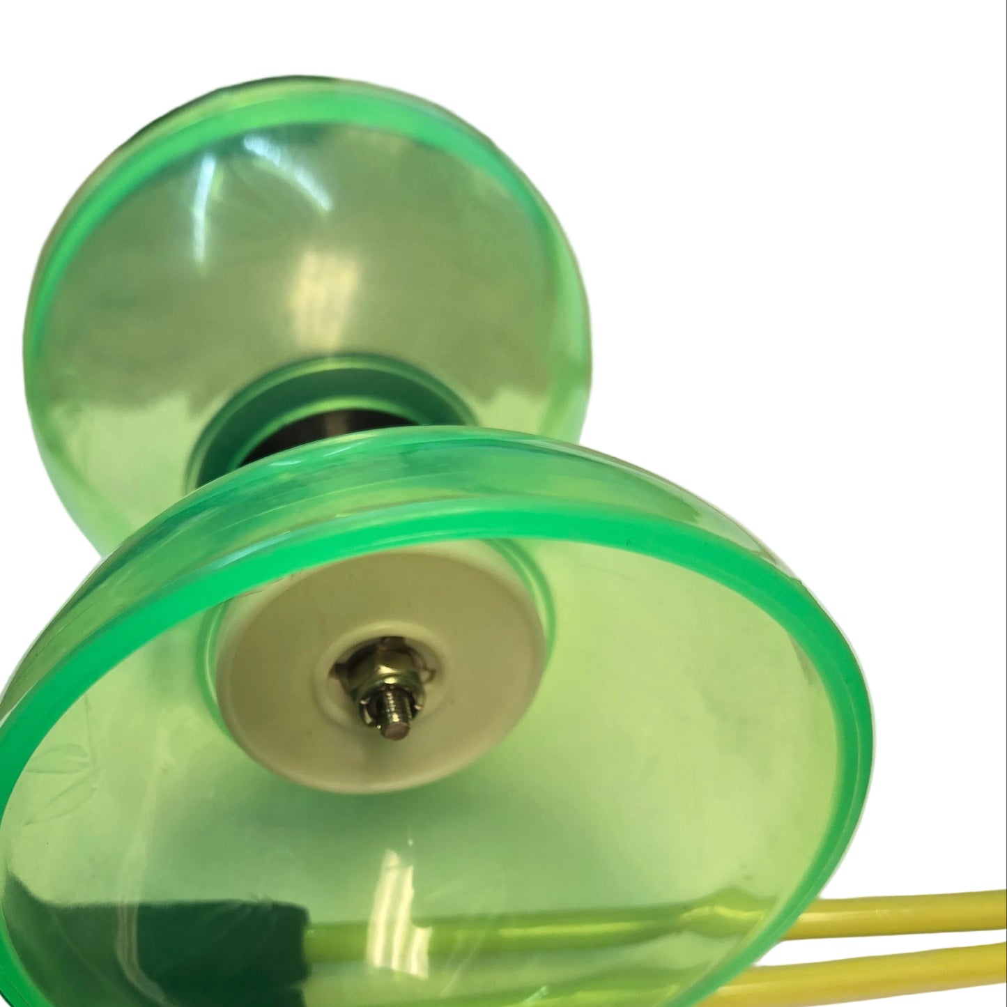 HB Aura Bearing Diabolo - Limited Edition in green on it's side with yellow primo handsticks underneath