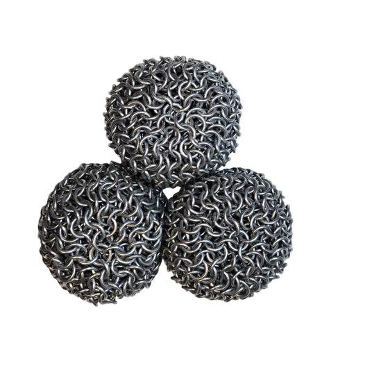Three chain mail juggling balls on a white background.