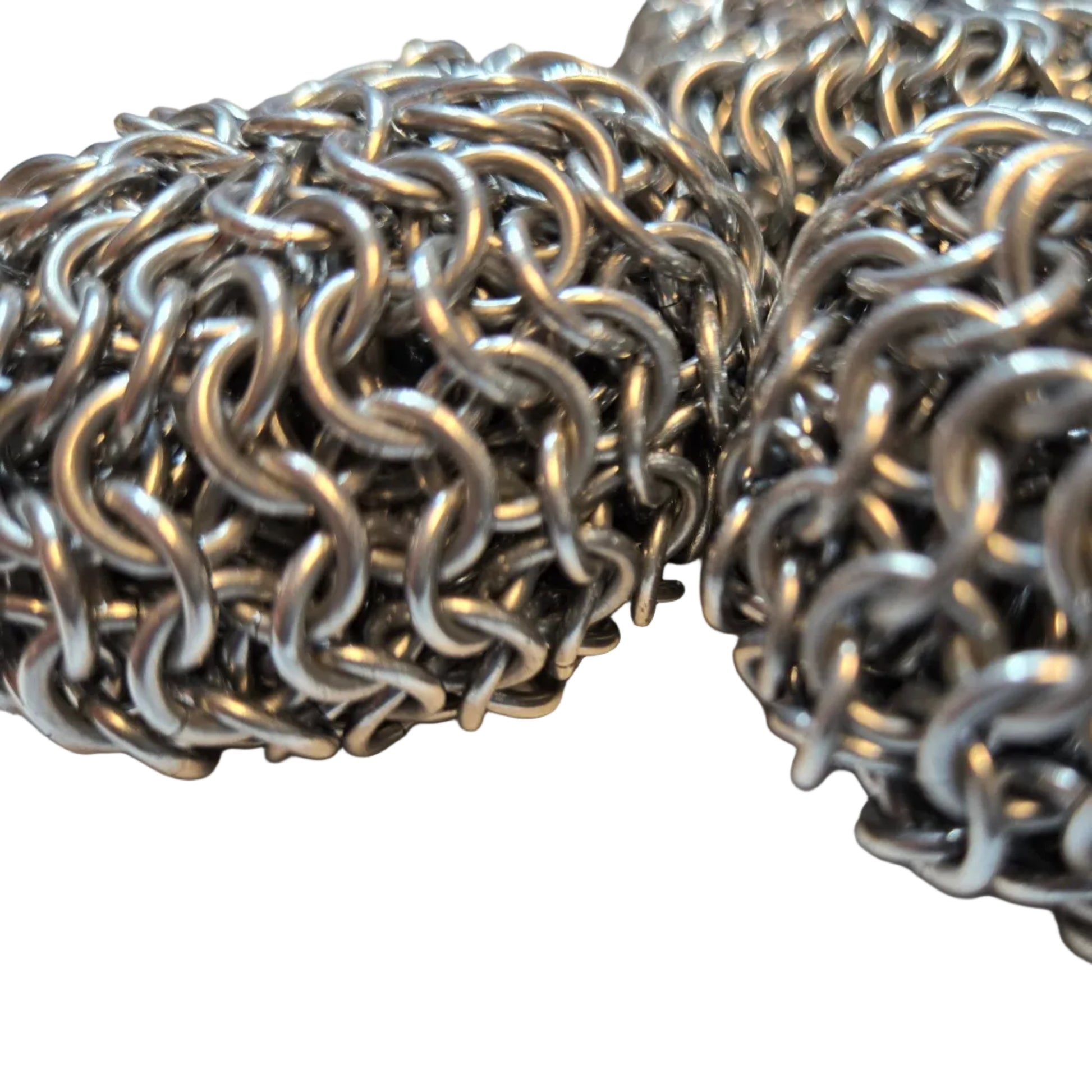 Close-up of metal chainmail on a light background