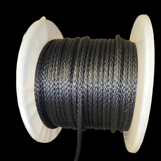 Spool of black Technora rope on a white reel with blurred background